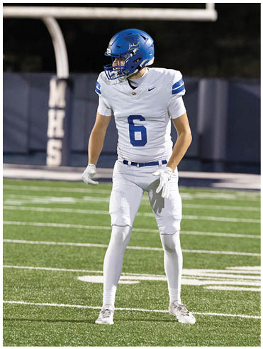 A football player is sliding on the ground. Description generated by AI