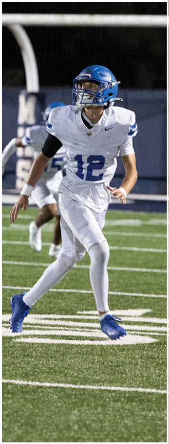A football player running on the field. Description generated by AI