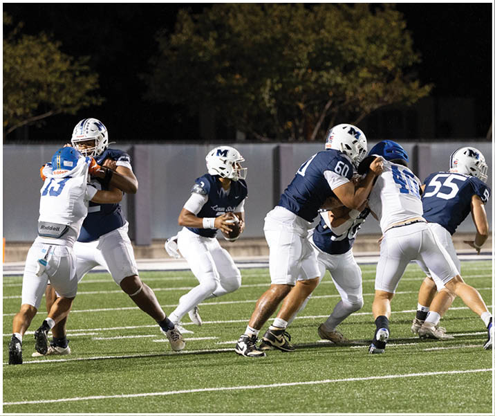 A group of football players wearing black and white uniforms. Description generated by AI