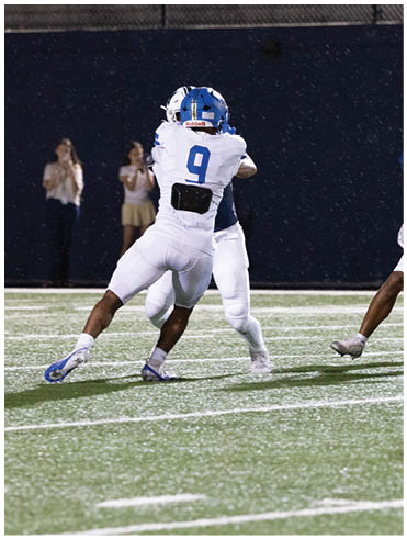 A football player is sliding on the ground. Description generated by AI