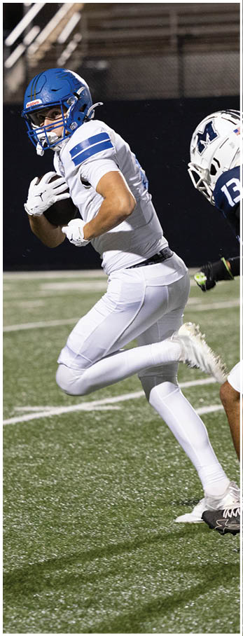 A football player running on the field. Description generated by AI