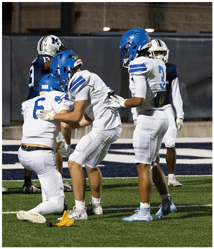 A group of football players wearing black and white uniforms. Description generated by AI