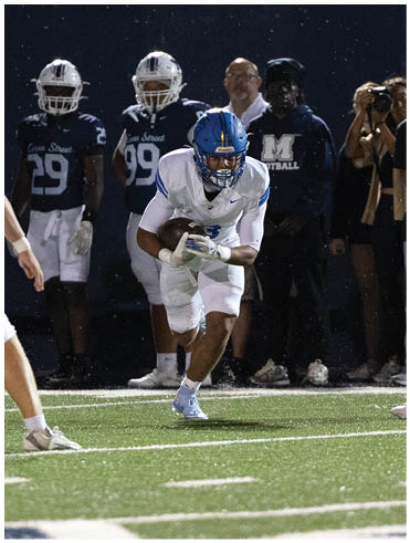 A football player is sliding on the ground. Description generated by AI