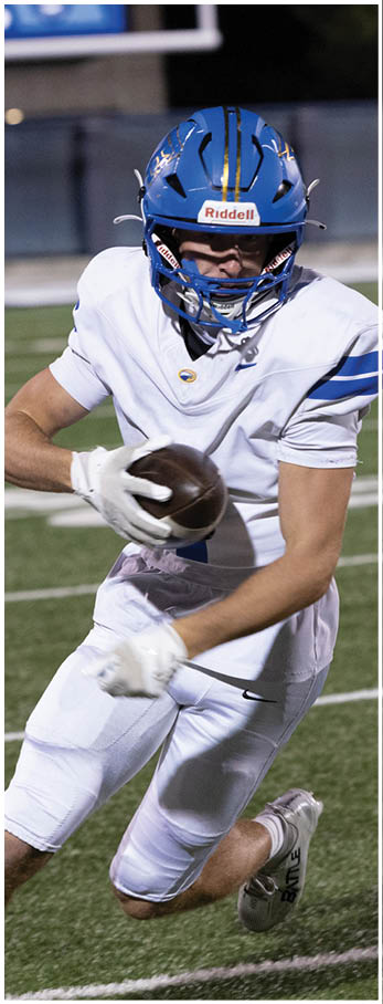 A football player running on the field. Description generated by AI