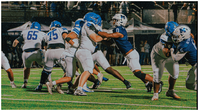 A football player wearing a blue and white uniform. Description generated by AI