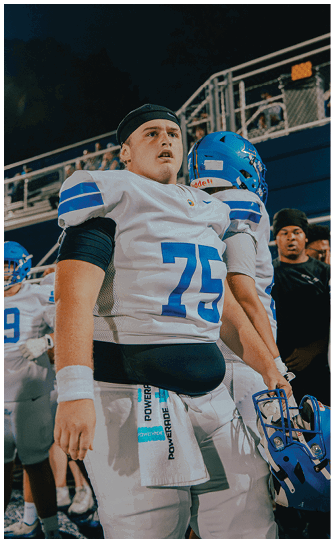 A football player catching a ball. Description generated by AI