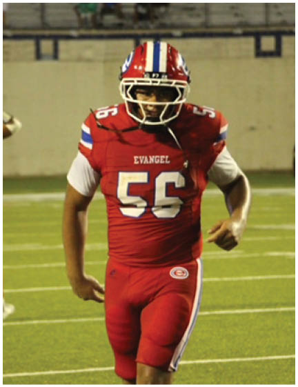A football player wearing a blue and white uniform. Description generated by AI