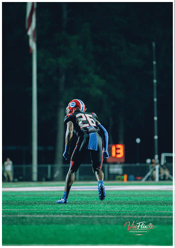 A football player running on the field. Description generated by AI