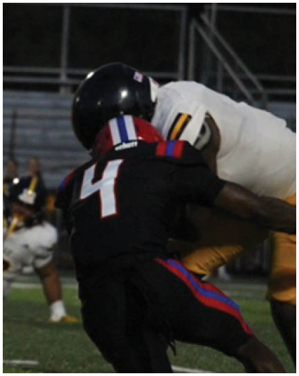 A football player wearing a blue and white uniform. Description generated by AI