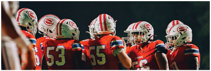 A group of football players on a field. Description generated by AI