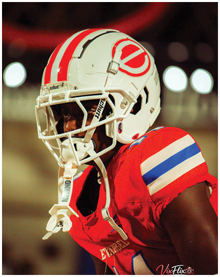 A football player wearing a blue and white uniform. Description generated by AI