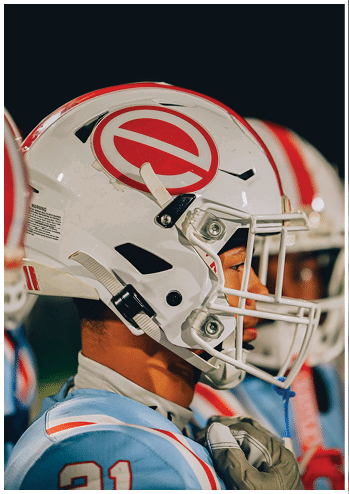 A football player running on the field. Description generated by AI