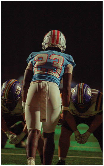 A football player running on the field. Description generated by AI