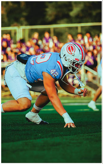 A football player running on the field. Description generated by AI