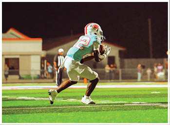 A football player is sliding on the ground. Description generated by AI