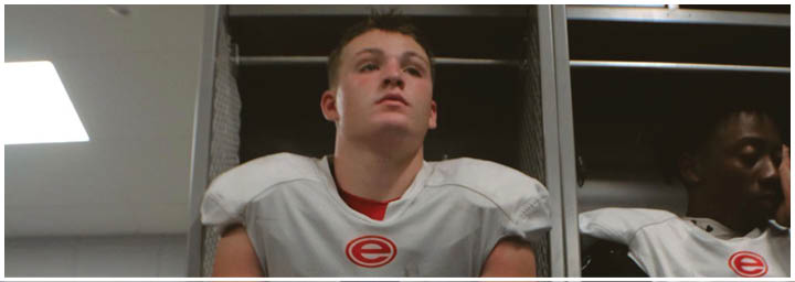 A football player is sliding on the ground. Description generated by AI