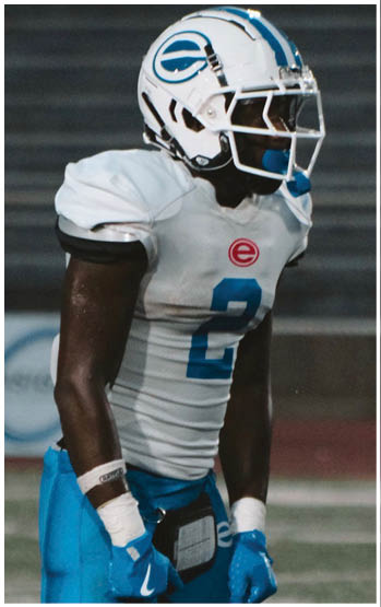 A football player running on the field. Description generated by AI