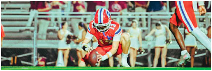 A group of football players on a field. Description generated by AI