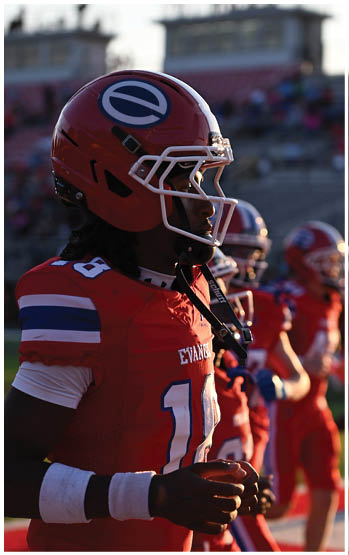 A football player running on the field. Description generated by AI