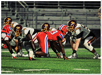 A football player is sliding on the ground. Description generated by AI