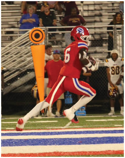 A football player wearing a blue and white uniform. Description generated by AI