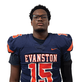 A person wearing glasses and a navy blue football jersey with orange and white lettering that reads “EVANSTON" and the number 15 stands against a white background. Description generated by AI