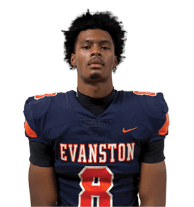 Person with curly hair wearing a dark sports jersey with orange and white numbers is shown against a white background. Description generated by AI
