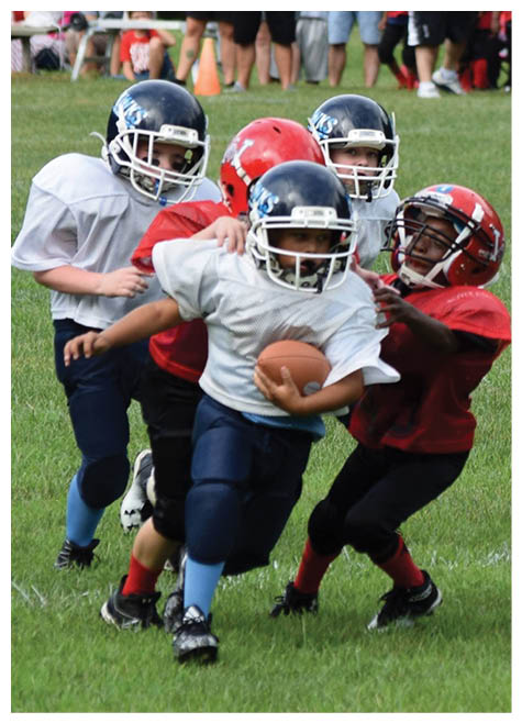 Two football players wearing black jerseys and holding hands. Description generated by AI