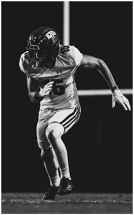 A football player wearing a blue jersey with the number 58 on it. Description generated by AI