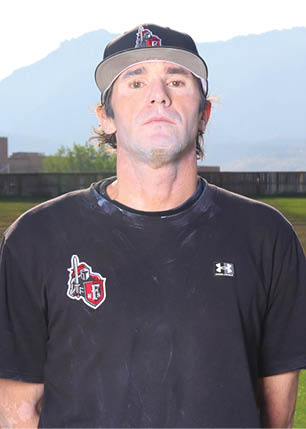 A young man wearing a white and black jersey with the number 14 on it. Description generated by AI