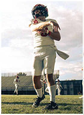 A football player wearing a blue jersey with the number 58 on it. Description generated by AI