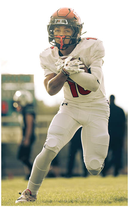 A football player wearing a blue jersey with the number 58 on it. Description generated by AI