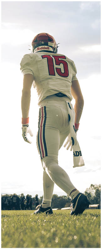 A football player wearing a blue jersey with the number 58 on it. Description generated by AI