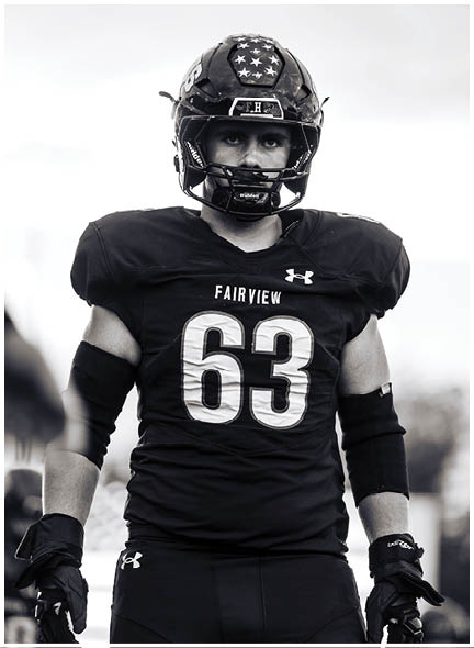 A football player wearing a blue and white uniform. Description generated by AI