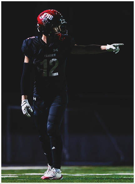 A football player wearing a blue and white uniform. Description generated by AI