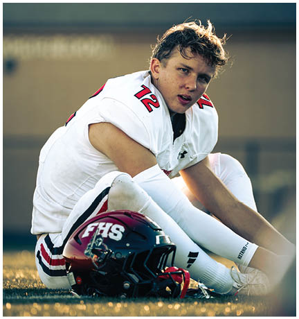 A football player running on the field. Description generated by AI