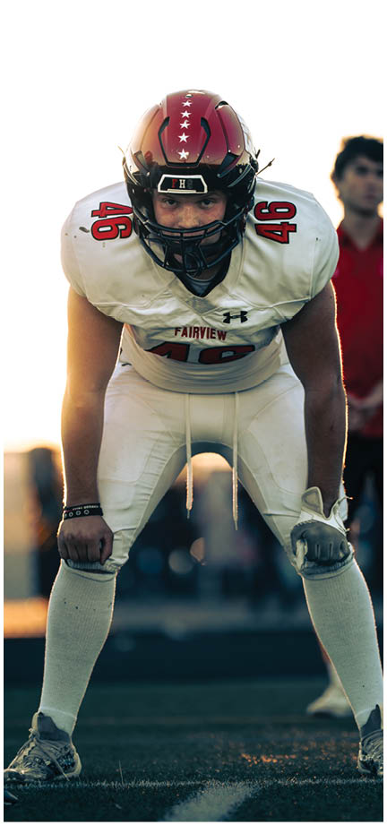 A football player wearing a blue and white uniform. Description generated by AI