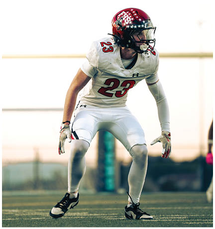 A football player running on the field. Description generated by AI