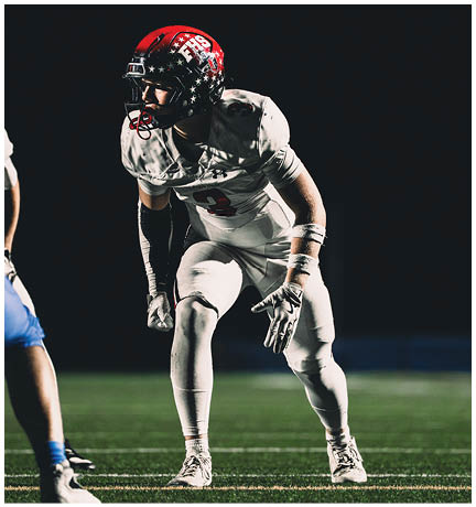 A football player running on the field. Description generated by AI