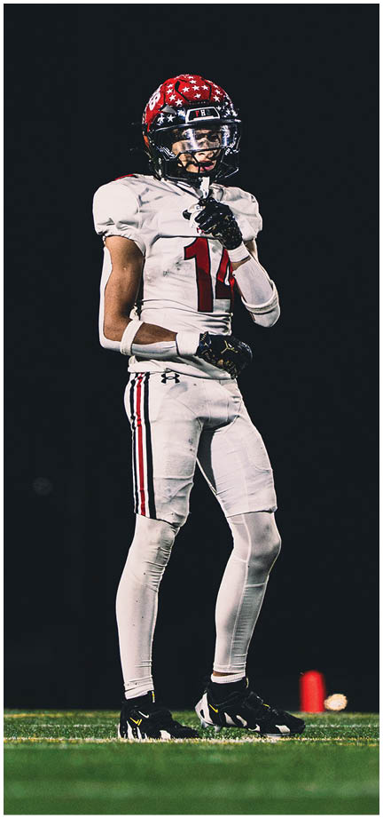 A football player wearing a blue and white uniform. Description generated by AI