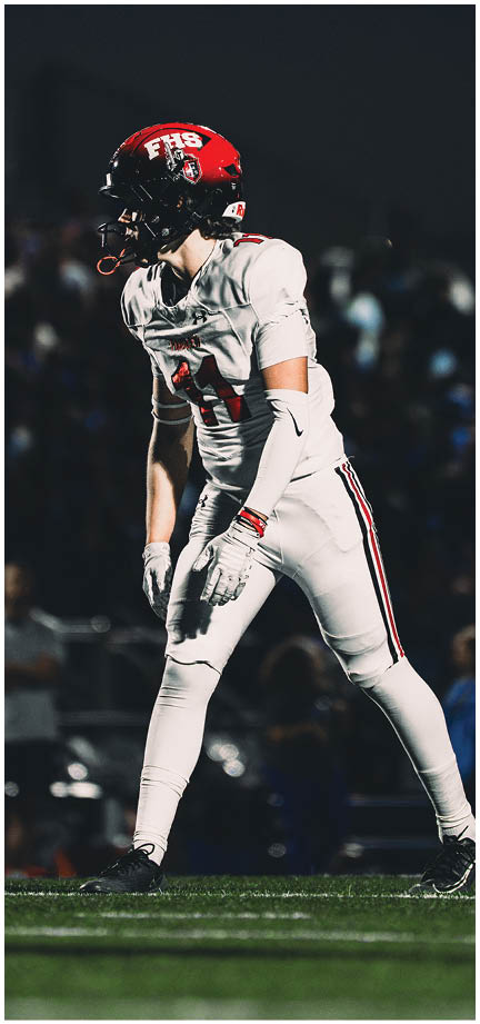 A football player wearing a blue and white uniform. Description generated by AI
