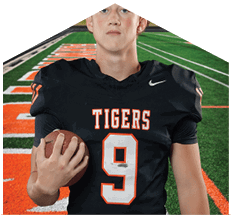 A young man wearing a white jersey with the number 10 on it. Description generated by AI