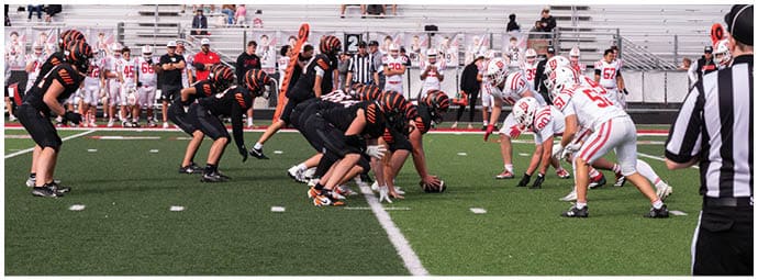 A football player wearing a blue and white uniform. Description generated by AI