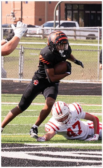 A football player catching a ball. Description generated by AI