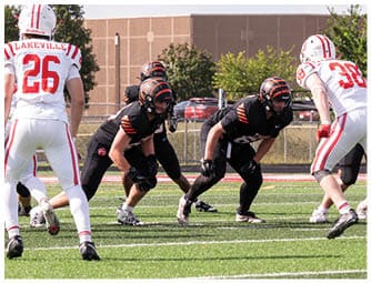 A group of football players on a field. Description generated by AI