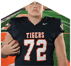 A young man wearing a white jersey with the number 10 on it. Description generated by AI
