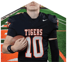 A young man wearing a white jersey with the number 10 on it. Description generated by AI