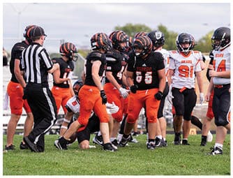 A group of football players on a field. Description generated by AI