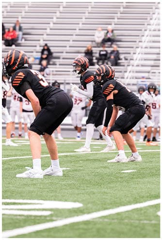 A football game is being played on a field. Description generated by AI