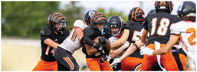 A football player wearing a blue and white uniform. Description generated by AI